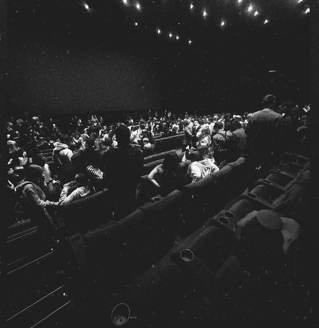 Cinema audience watching a film in a dark auditorium